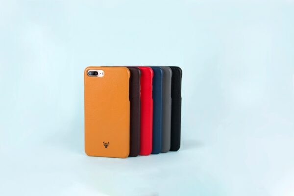 Collection of stylish smartphone cases in various colors arranged neatly, perfect for tech enthusiasts.